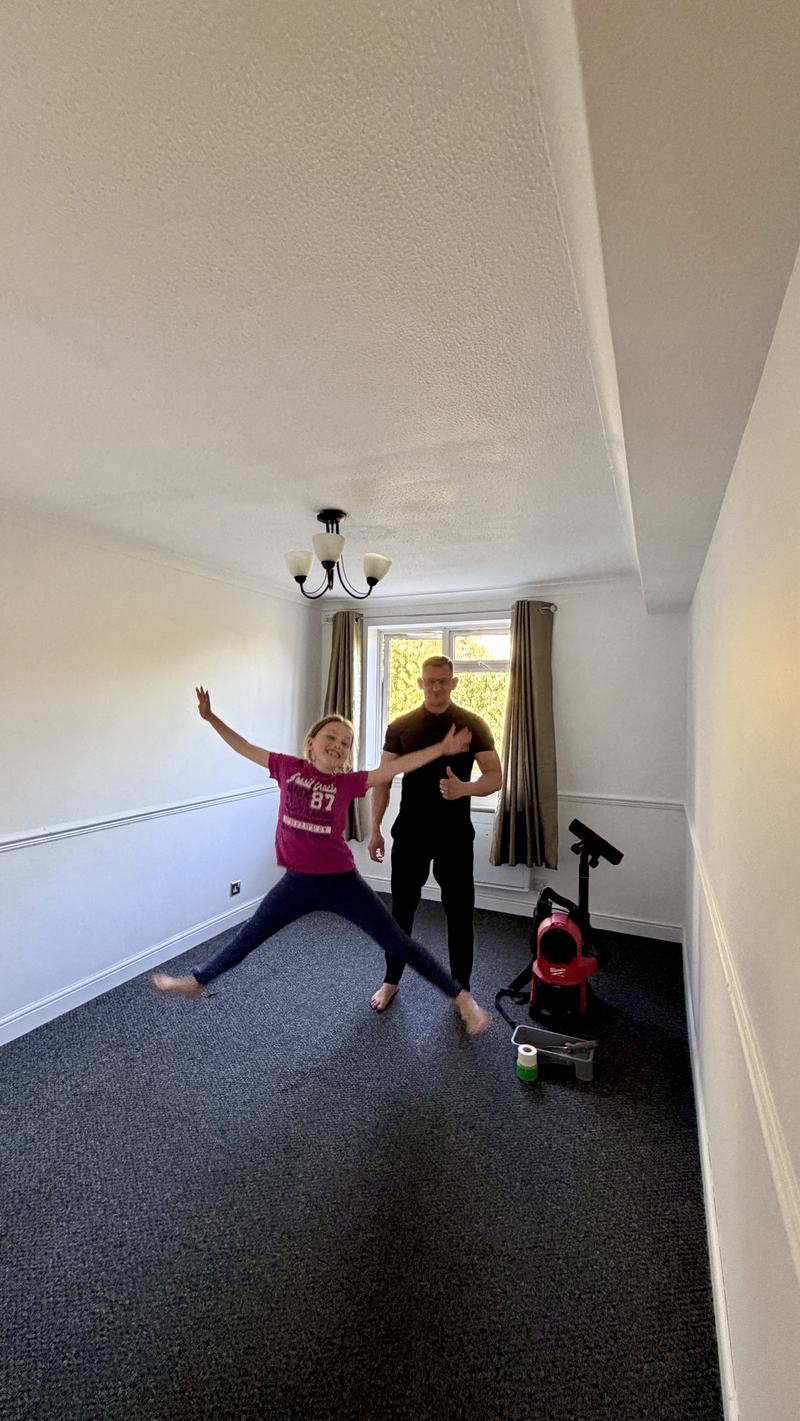 Alex with his daughter in a freshly painted bedroom