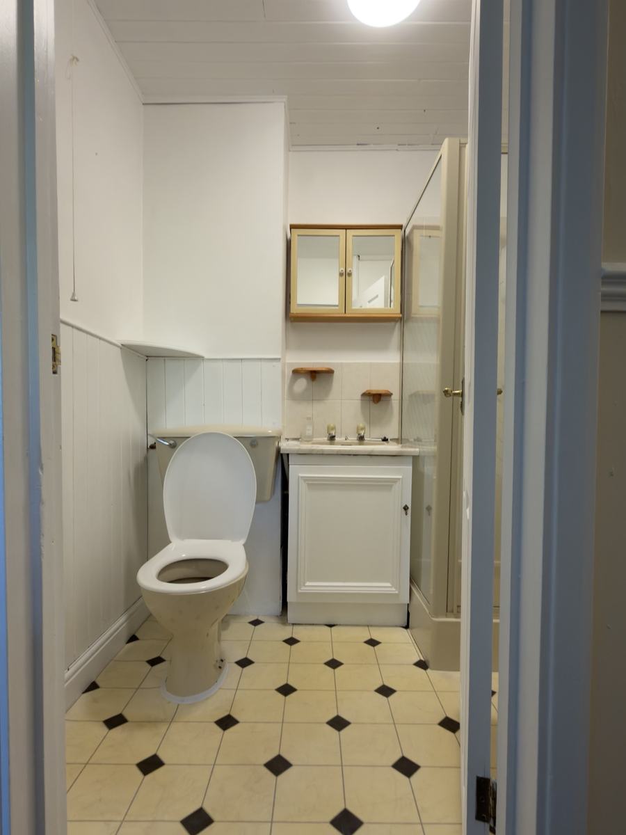 Bathroom after: cladding and vanity painted white