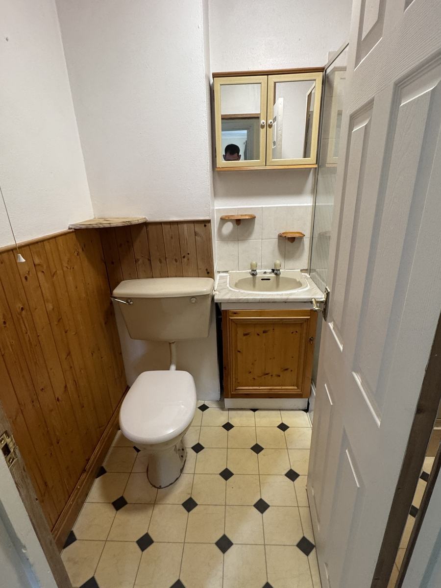 Bathroom before: pine cladding and pine vanity unit