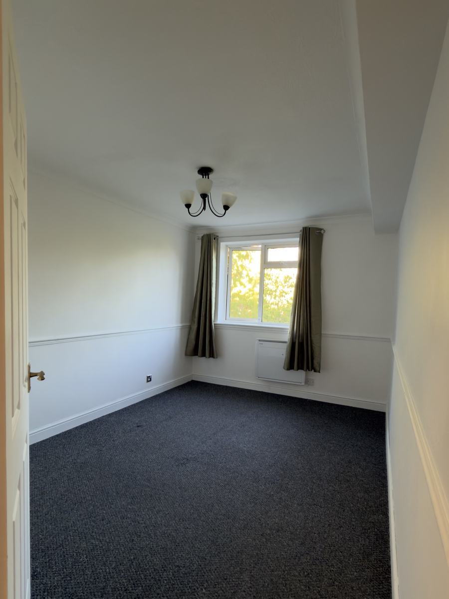 Bedroom after: white walls, ceiling and woodwork