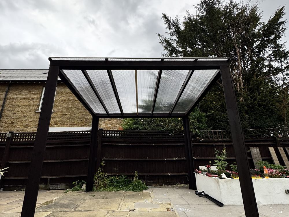Finished timber pergola with a clear polycarbonate roof